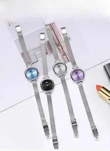 Flat lay of Gedi minimalist women's watches with colorful dials and mesh steel bands