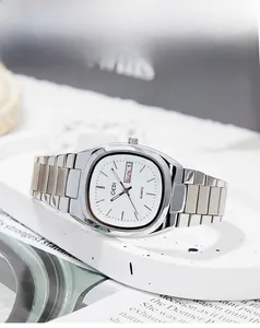 Detail view of silver oval quartz watch featuring dual day-date display and steel strap