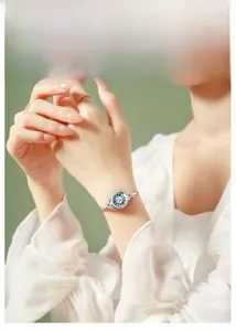 Detail of elegant silver bracelet watch with light blue dial on a woman's wrist