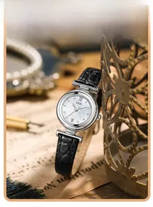 Retro quartz watch detail with mother-of-pearl dial and black crocodile pattern leather strap