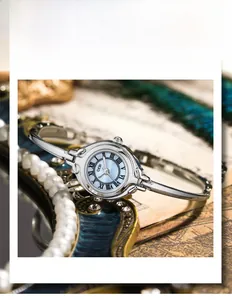 Detail of GEDI vintage bangle watch with light blue dial and Roman numerals on retro background