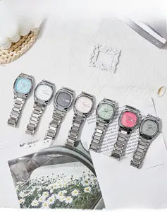 Flat lay of oval quartz watches in multiple colors with dual calendar on metal bracelets