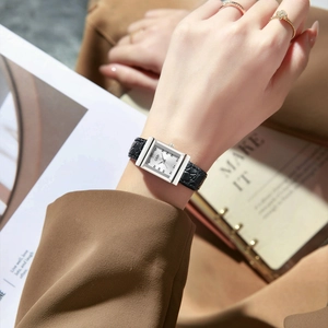 Retro square silver watch with black pebble leather strap for women shown on a model wrist