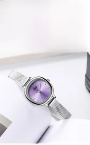 Detail of silver mesh band watch with sunray purple dial on a clean white background