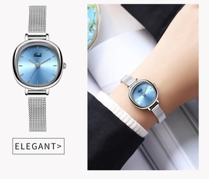 Detail view of silver mesh strap watch with light blue dial and wrist wear display