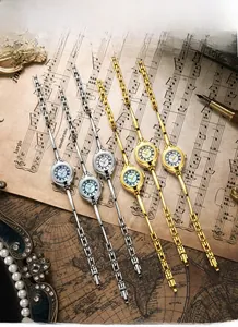 Classic small dial quartz watches in gold and silver colors on vintage sheet music