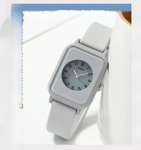 Detailed view of grey silicone strap and black Arabic numerals on the rectangular watch dial