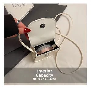 Detail of mini white leather bag showing internal capacity for cushion foundation