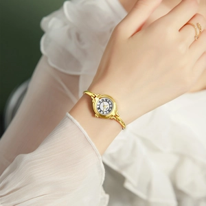 Elegant vintage gold bangle watch with white Roman numeral dial for women wrist