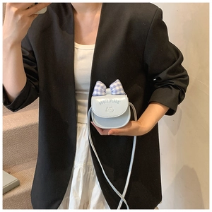 Detail of light blue mini crossbody bag with plaid bow and cat embossed design