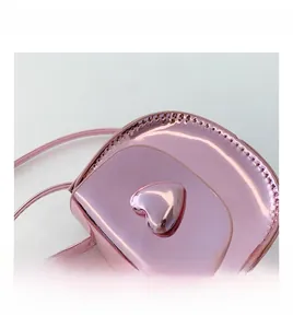 Detail of pink metallic mini heart bag for kids with fine stitching and 3D heart decor