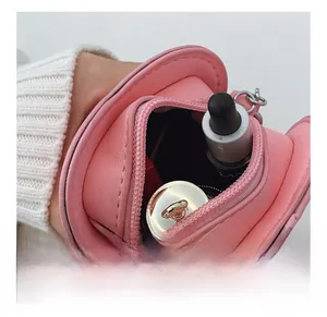 Pink quilted leather heart bag showing internal space with a zipper closure and chain