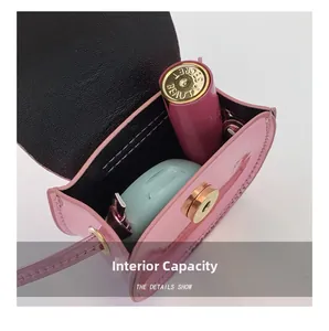 Detail of pink patent leather mini bag interior showing capacity for small essentials
