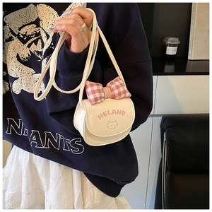 Detail of cream white mini crossbody bag with red checkered bow and cute cat embroidery