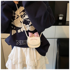 Detailed close-up of a white mini PU leather crossbody bag with red checkered bow and cat embroidery