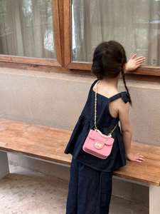 Pink mini crossbody bag for girls with pearl handle and golden chain strap detail