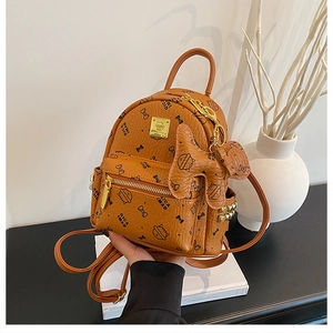 Detail of caramel brown backpack with cartoon cat prints and gold metal zippers