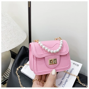 Detail of pink mini pearl handbag featuring gold hardware clasp and textured PU leather