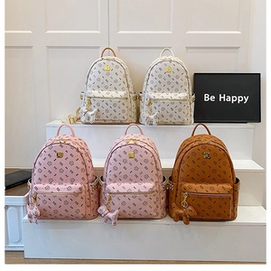 Detail view of stylish women backpacks in five colors with floral patterns and cute charms