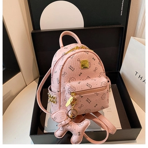 Detailed view of pink mini backpack with litchi texture in luxury black gift box