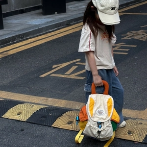 Detailed view of kids' color-block canvas backpack with vibrant pockets and drawstring top