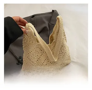 Close-up of beige crochet knit tote bag showing hollow geometric mesh texture and craftsmanship
