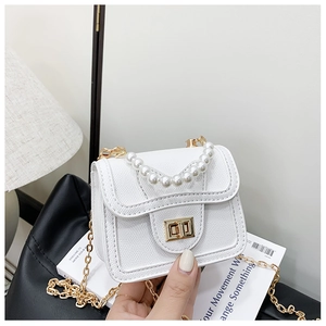 Close-up of white mini pearl handbag featuring litchi texture PU leather and gold chain
