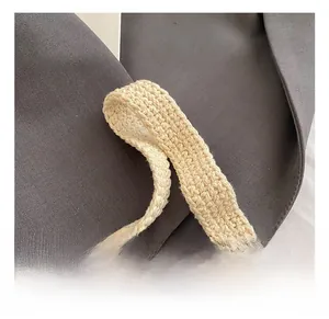 Detail showing high-quality hand-woven cream crochet handle with soft canvas texture