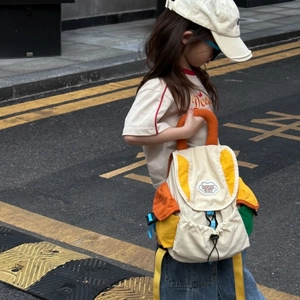 Detailed view of color-block school backpack with vibrant straps and cloud-shaped logo