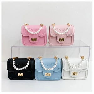 Detailed view of mini pearl handbags in multiple colors with cross-grain leather texture