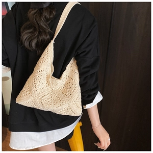 Detail of hand-woven cream crochet shoulder bag with hollow diamond knit patterns