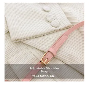 Detail of adjustable pink faux leather shoulder strap with gold-tone buckle closure