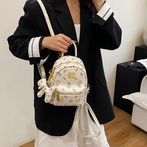 Miniature white faux leather cat print backpack with bear charm and golden zipper detail