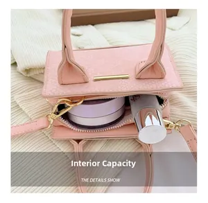 Pink faux leather mini handbag featuring snake-embossed texture and gold-tone metal hardware
