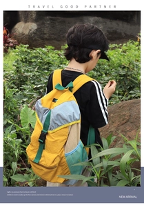 Kids color-block nylon backpack with ergonomic straps shown in outdoor setting