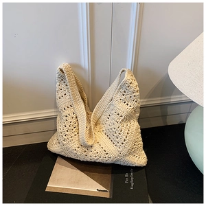 Detailed view of French style cream crochet tote bag with intricate floral weave patterns