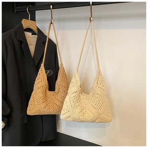 Detailed close-up of handmade crochet hobo bag showing bohemian hollow knit texture