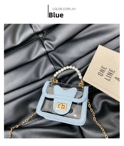 Détail du mini sac gelée bleu avec poignée en perles et bandoulière chaîne dorée