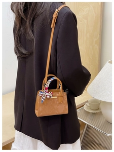 Brown faux leather mini shoulder bag with stone texture and elegant silk scarf handle