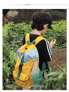 Detail view of colorful outdoor backpack with drawstring closure and mesh side pockets