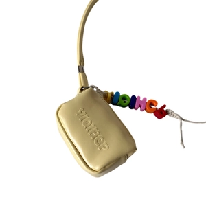Mini yellow leather neck bag for kids featuring colorful letter beads and embossed logo