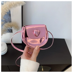 Detail of pink metallic mini heart crossbody bag with glossy patent leather finish