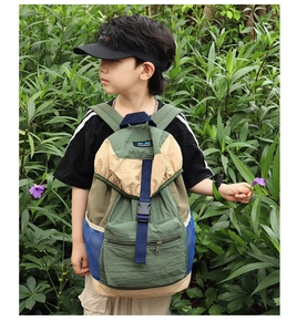 Detail view of durable multi-color kids backpack with adjustable buckles and side mesh pocket