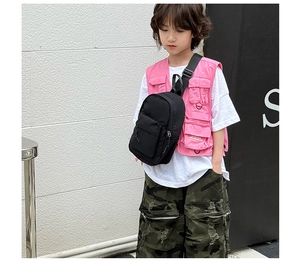 Détail d'un sac de poitrine minimaliste en nylon noir pour enfant sur fond de style urbain