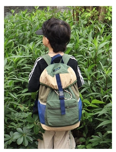 Outdoor view of kids' color-block drawstring backpack with large storage and buckle