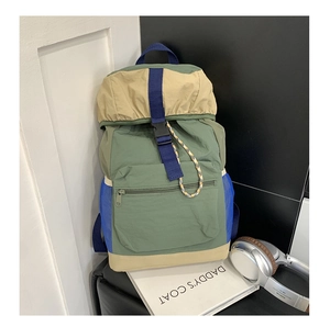 Detail of color-block functional backpack with drawstring cords and side mesh pockets