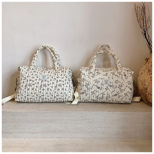 Detail of floral quilted cotton tote bags with sturdy handles and vintage flower patterns