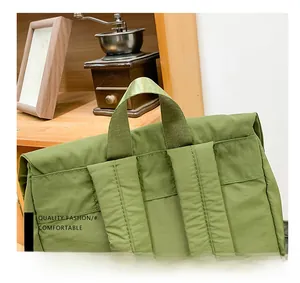 Close-up of the reinforced green nylon handle and woven strap on a durable kids backpack