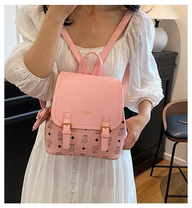 Close-up of pink mini backpack featuring diamond cat pattern and gold metal buckle detail