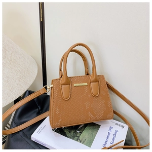 Detailed view of brown synthetic leather crossbody bag with snake skin pattern texture